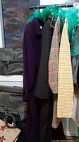 All four outerwear items hung on rack