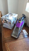 Shark Euro-Pro hand vacuum with box and visible power cord.