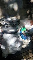 Four rusty 17-inch Honda CR-V rims stacked with car care products in bin beneath, showing condition and material.