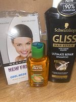 Lot photo showing Schwarzkopf Gliss Ultimate Repair Shampoo, Garnier Fructis Moroccan Smoothing Oil, and Cool Mesh Weaving Cap.