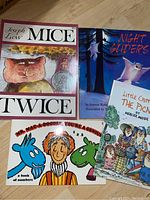 Photo showing the covers of five paperback children's books: 'Mice Twice' with a cat illustration, 'Night Gliders' featuring a flying squirrel at night, 'Little Critters The Picnic' with many critters having a picnic, and 'Mr. Mac-a-Doodle, You're a Genius' with a stylized man and colored animals.