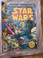 Photo of Star Wars Marvel Special Edition #1 cover showing main characters Luke, Leia, Darth Vader, and others with lightsabers.