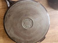 Bottom of enameled cast iron pan showing circular Copco Denmark brand marking