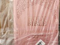 Pink Holy Bible King James Version, front cover with embossed gold text and decorative scroll design, wrapped in plastic