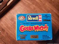 Box top showing brand, scale, and model description 'Woody Woodpecker Chevy' with 'Guess Who?!' logo.