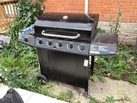 Front view of the Master Chef 5-burner gas BBQ grill showing lid, temperature gauge, and control knobs.