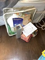 Wide shot showing the packaged quilt, sewing basket, paintbrushes, and other contents