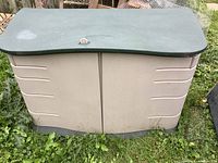 Front view of the Rubbermaid deck box showing double doors and locked lid.