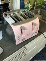 Front view of Mary Kay 4 slice toaster with control knobs, buttons, and logo