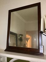 Front view of the rectangular wood framed mirror showing the full mirror and frame.