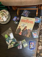 Overview of the lot showing assorted vintage toys, unopened hockey cards, scrapbook and colouring book.