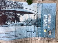 Box showing umbrella parasol image and partial usage instructions.