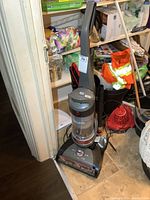 Full view of the Hoover WindTunnel upright vacuum cleaner showing overall shape, handle, canister and hose attachment.