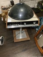 Front view showing pedestal radio with black dome and control panel