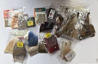 Lot of approximately 27 new fly fishing materials including various feathers, synthetic fibers and animal hairs in sealed bags.