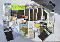 Overview of all fly fishing tying materials showing packaging and assortment.