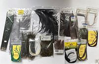 Lot of various new fly fishing tying feathers in sealed original bags including emu, goose, ostrich, and other types.