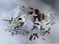 Overall view of assorted hand crafted fly fishing lures with attached labels and bags indicating different fly types.