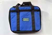 Front view of intact blue and black fly fishing case with visible 'Outfitters' label on side.