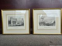 Two framed black and white prints depicting scenes of Montreal on a wooden background