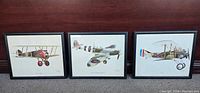 Three framed John Batchelor fighter plane prints showing side profiles of WWI and WWII aircraft.