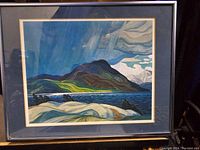 Front view of framed print showing "Summer Storm" landscape with storm clouds, mountain, water, and rocky foreground.
