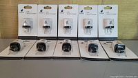 Photo showing ten iPlanet USB wall chargers in their original packaging lined up in a row