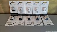 Front view showing 10 individually packaged iPlanet USB home wall chargers arranged in two rows.