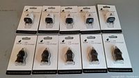 Bottom row of 5 black iPlanet USB Car Chargers in original packaging, cylindrical design visible