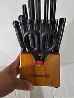 Front view of wooden Calphalon knife block holding knives and scissors