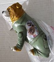 Side view of the dog figurine showing the painted Marine artwork on the jacket side and facial details.