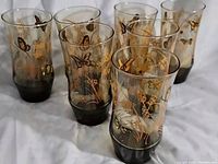 Eight Libbey Monarch Butterfly Wheat Glasses arranged in two rows, showing decoration and shape.