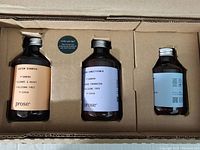 Photo of three Prose hair care products in a cardboard box: Custom Shampoo, Custom Conditioner, and a Cream.