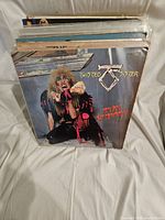 Stack of vintage vinyl records showing front album cover with Twisted Sister 'Stay Hungry' album