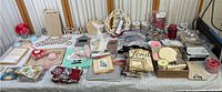 Overview of all crafting items laid out on a table including wooden signs, fabric, ribbons, crafting tools, and embellishments.