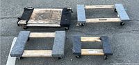 All four wooden rolling dollies arranged on asphalt, showing size difference and carpeted tops