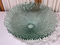Front angle photo of the entire large vintage ice design art glass bowl showing radial ridges and textured glass surface.