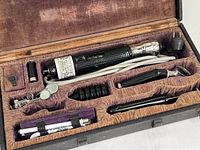 Wide view of electric Cameron's Vitrohm Potential Adjuster and accessories inside a hard case with padded compartments.