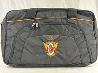 Front view of large black Timberland briefcase with CHP logo embroidered on front pocket, showing overall condition and design details.