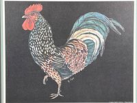 Close-up of the colorful rooster print with artist signature visible