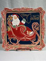Full view of the large ceramic square platter featuring Santa Claus in sleigh with toys and 'Merry Christmas' text on deep blue background.