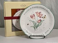 Full view of Lenox Butterfly Meadow serving plate on stand beside its original box showing overall condition and packaging.