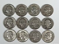 Obverse view of 12 pre-1965 US silver quarters showing George Washington's profile.