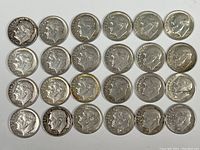 Top-down view of all 24 Roosevelt dimes arranged in 4 rows showing obverse side with Roosevelt's profile.