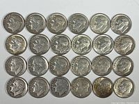 Top view of all 24 Roosevelt dimes arranged in 4 rows of 6, showing obverse side with Roosevelt profile and LIBERTY inscription.