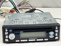 Front angle view of Phase Linear Jensen UCD200 car stereo showing front panel including button controls and wiring harness.