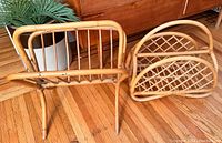 Two mid century bamboo magazine racks on hardwood floor, showing natural bamboo color and design details