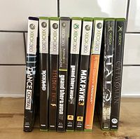 9 Xbox and Xbox 360 games lined up side view showing titles on spines