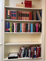 Four shelves of books focused on WW2, Churchill, royalty and general history. Includes mix of bindings and colors.