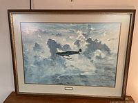 Full image of framed Lone Spitfire print showing the Spitfire aircraft in clouds.